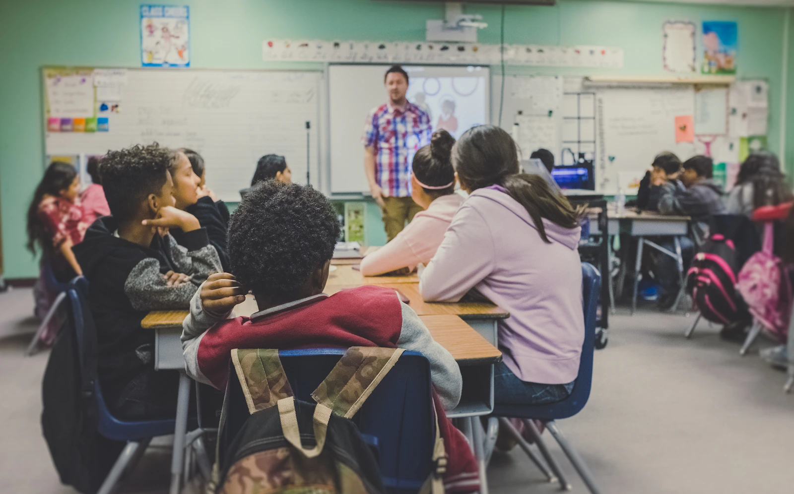 Stock photograph of older learners listening to a teacher